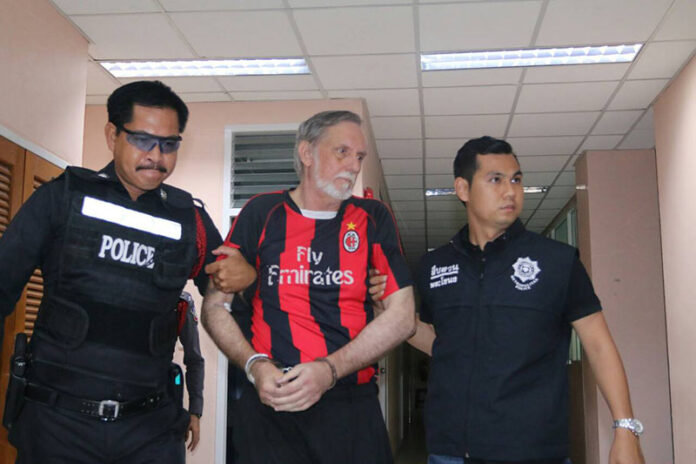 Herbert La Fon, 63 of the United States, is led from an interrogation session on Sept. 30 in Bangkok.