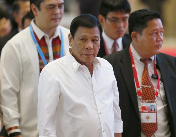 Philippine President Rodrigo Duterte, center, arrives Tuesday at the National Convention Center for scheduled bilateral meetings with ASEAN leaders on the sidelines of the 28th ASEAN Summit in Vientiane, Laos. Photo: Bullit Marquez / Associated Press