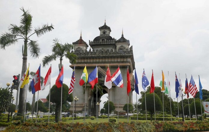 Flags of the 10-member ASEAN (Association of Southeast Asian Nations) and its dialogue partners are placed around the Patuxay Monument in downtown Vientiane, Laos on Monday. Photo: Bullit Marquez / Associated Press