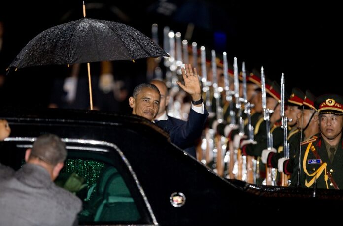 U.S. President Barack Obama waves upon his arrival at Wattay International Airport in Vientiane, Laos on Monday. Photo: Gemunu Amarasinghe / Associated Press