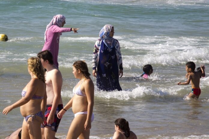 Muslim women bathe last Friday in the Mediterranean sea in Tel Aviv, Israel. Photo: Ariel Schalit / Associated Press