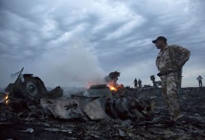People walk among debris of a passenger plane July 17, 2014, near the village of Grabovo, Ukraine. Photo: Dmitry Lovetsky / Associated Press