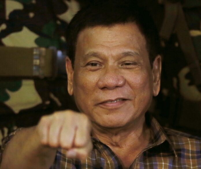 Philippine President Rodrigo Duterte gestures with a fist bump during his visit to the Philippine Army's Camp Mateo Capinpin at Tanay township in August in Manila, Philippines. Photo: Bullit Marquez / Associated Press
