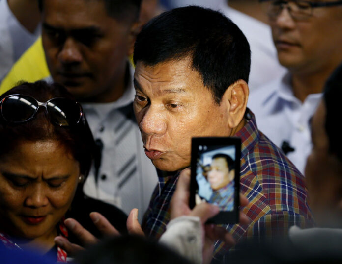 Philippine President Rodrigo Duterte talks to the media after welcoming Overseas Filipino Workers who were repatriated back to the country on Wednesday at the Ninoy Aquino International Airport. Photo: Bullit Marquez / Associated Press
