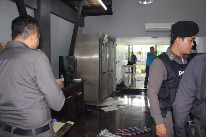 Police search the shophouse on Bangkok’s Soi Sukhumvit 56 Tuesday where the dismembered body was found inside a cold storage.