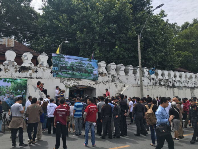 City staff and members of the media outside the gates of Pom Mahakan, which were closed Saturday morning to stymie demolition by the city.
