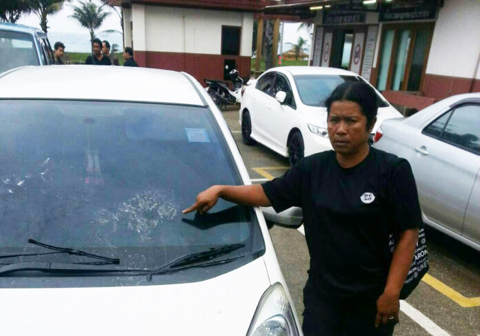 One of the aggrieved parties points to damage allegedly inflicted on a Honda Jazz by an intoxicated Russian tourist early Tuesday morning.