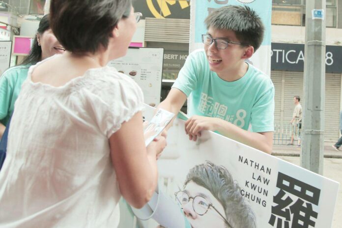 Joshua Wong on Sept. 4 shakes hand with a voter during his party's election campaign in Hong Kong. Photo: 香港眾志 Demosistō / Facebook