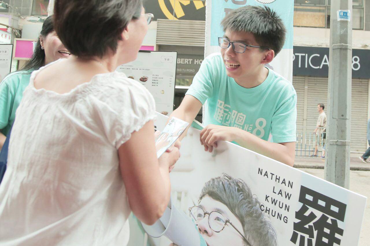 Joshua Wong on Sept. 4 shakes hand with a voter during his party's election campaign in Hong Kong. Photo: 香港眾志 Demosistō / Facebook