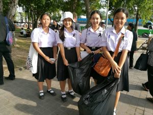 Student volunteers on trash duty Thursday at the Sanam Luang in Bangkok.