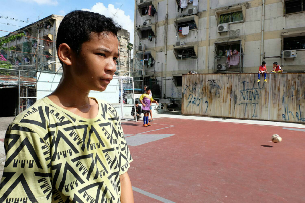 Nawaphol ‘Most’ Piangtakoe, 13, talks Thursday on an irregular football field built between buildings 1 and 2 in Bangkok's Khlong Toei district.