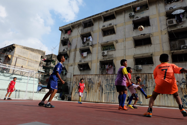 Wiliyak ‘Pai’ Phromjan, 10, at left, and Phuwanat ‘Mike’ Piangtakoe, 12, on the soccer field Thursday in Khlong Toei.