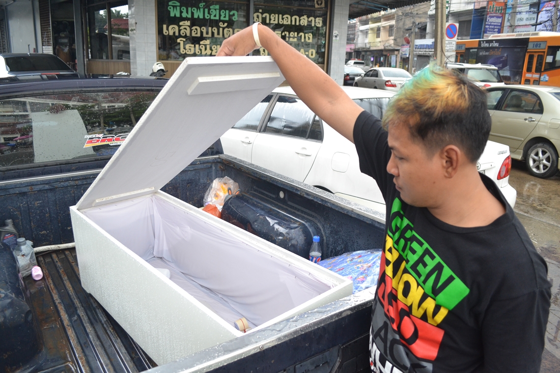 Sutthirat Wangklang shows reporters Tuesday the coffin brought for his newborn niece, only to learn her remains disappeared from the hospital morgue.