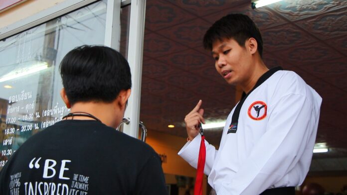 Chatchapol Laothammateep, at right, on Tuesday at his Chatchapol Taekwondo Gym in Prachinburi city.