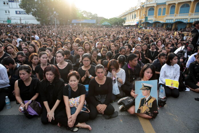 A crowd of black-clad mourners Friday outside the Grand Palace in Bangkok.