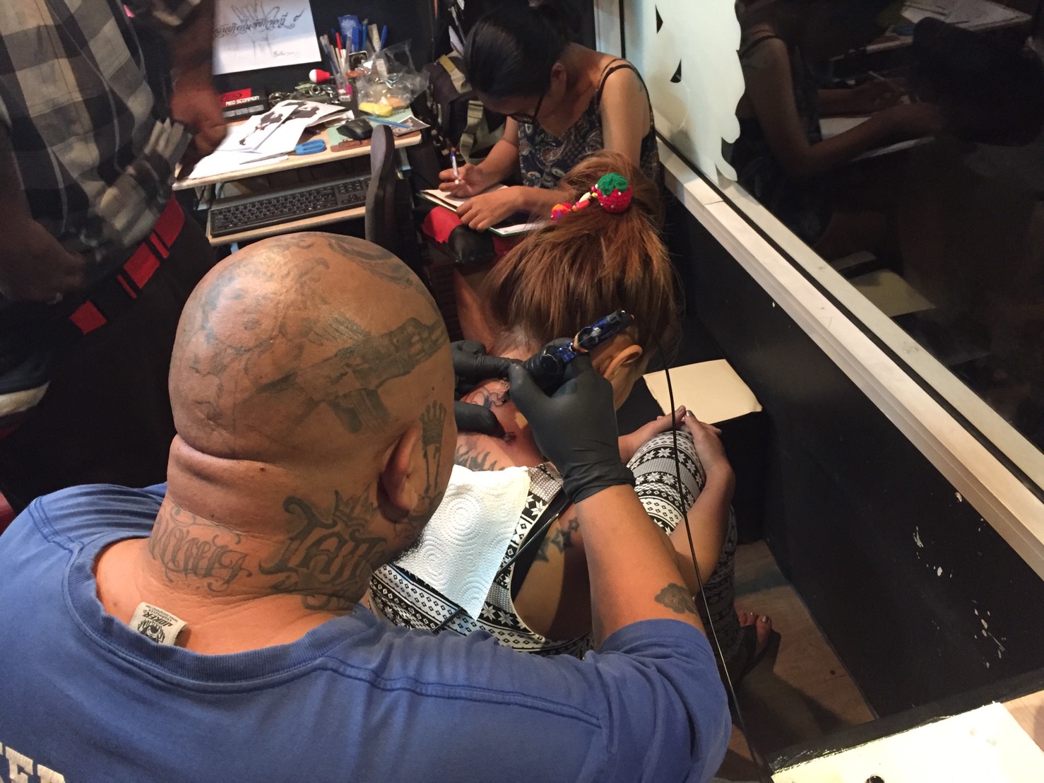 A tattoo artist inks tattoos for free in Pattaya