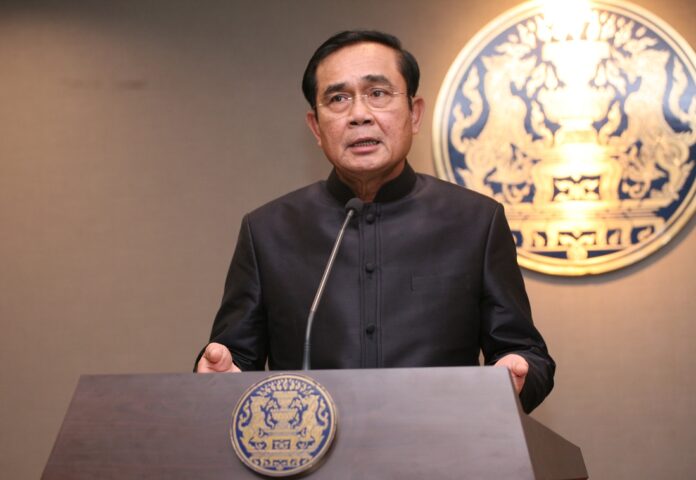Junta chairman Prayuth Chan-ocha speaks to reporters last October at Government House in Bangkok