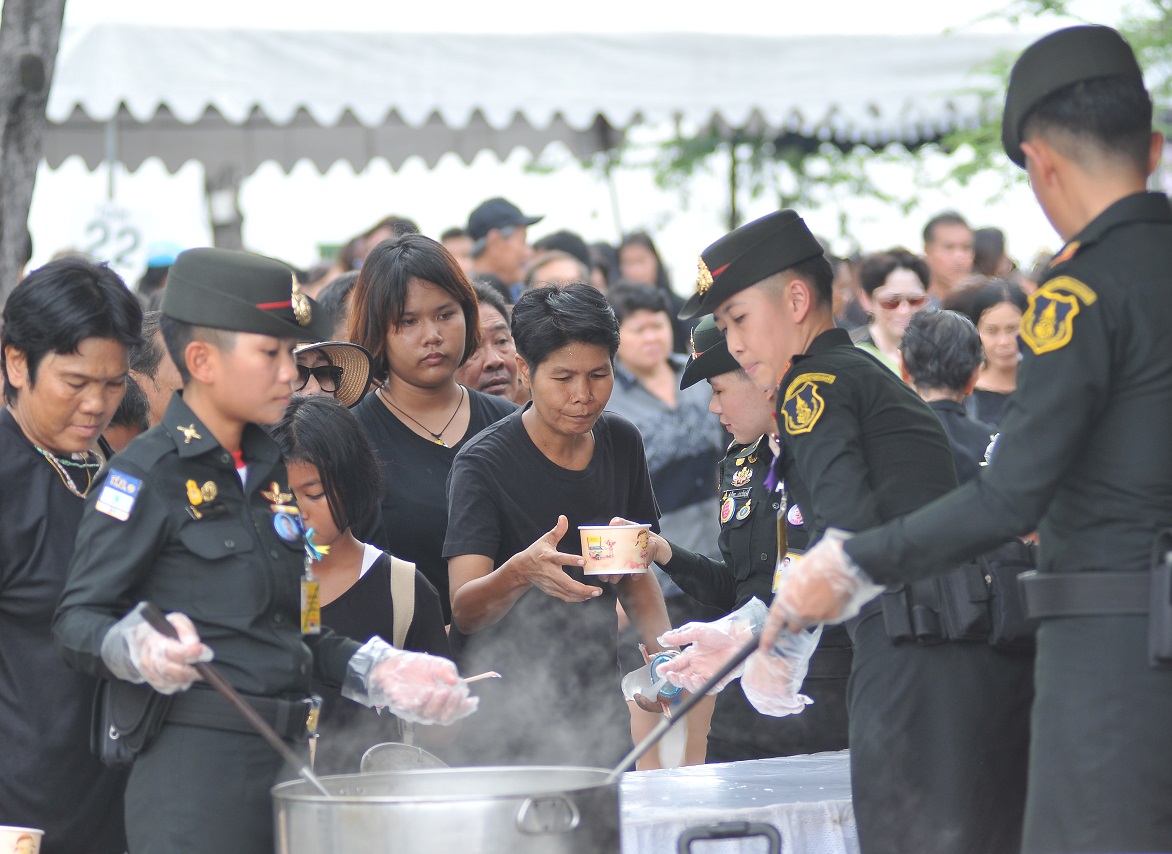 Mourners receive free food Tuesday at Sanam Luang in Bangkok.