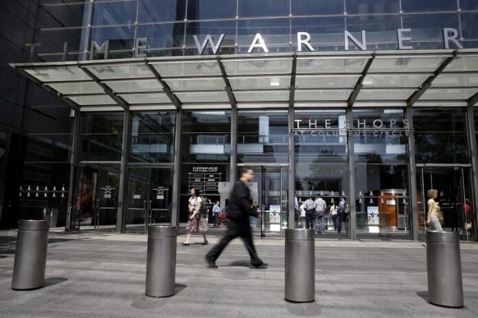 Pedestrians walk by an entrance to the Time Warner Center in New York on May 26, 2015. Photo: Mary Altaffer / Associated Press