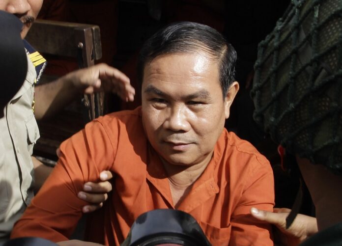 Cambodia's opposition lawmaker Um Sam An is escorted last September by prison security guards upon his arrival at Supreme Court in Phnom Penh, Cambodia. Photo: Heng Sinith / Associated Press
