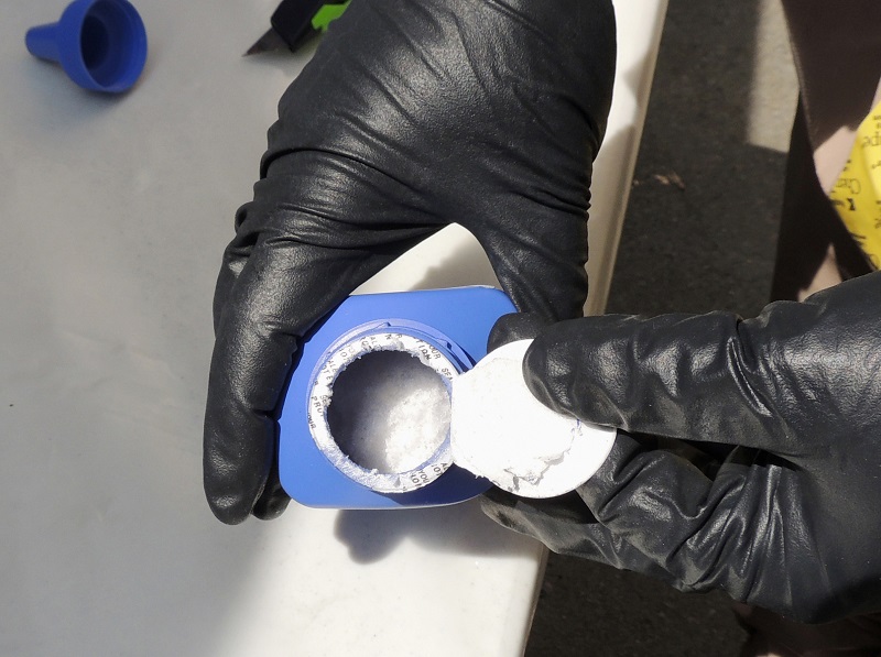 A member of the RCMP opens a printer ink bottle last June containing the opioid carfentanil imported from China, in Vancouver. Photo: Associated Press