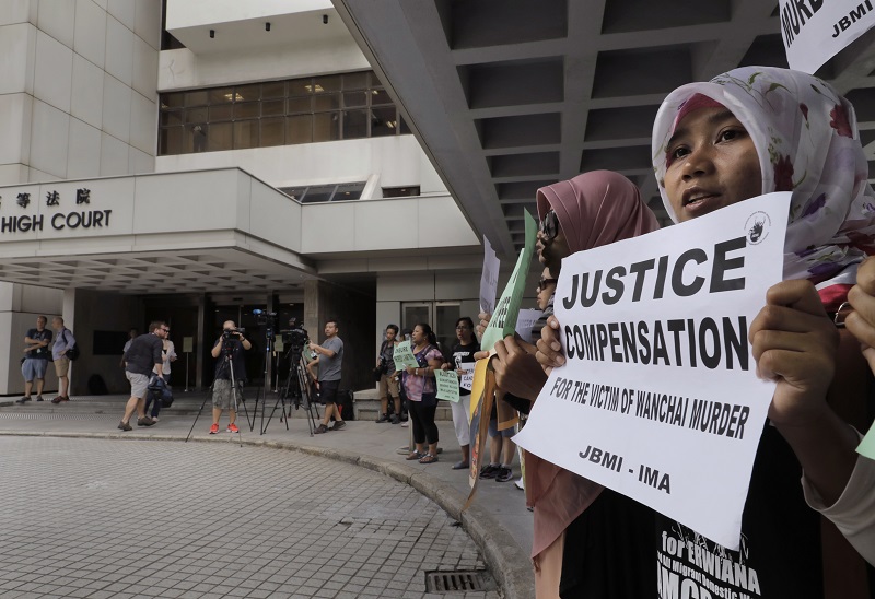 A migrant workers alliance group holds placards last October to protest the killings of two Indonesian women in 2014 outside the High Court in Hong Kong. Photo: Vincent Yu / Associated Press