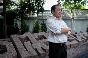 Krisadang Nutcharut stands in front of the memorial to the victims of the 1976 massacre at Thammasat University in Bangkok. Photo: Thitit Meetam