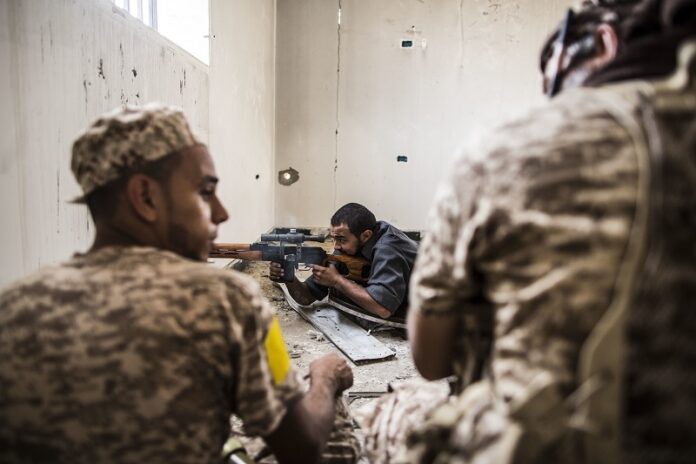 A sniper of the Libyan forces affiliated to the Tripoli government shoots against Islamic State positions, Sunday in Sirte, Libya. Photo: Manu Brabo / Associated Press