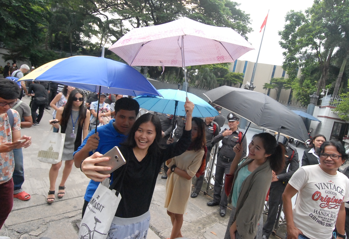 Activists hold umbrellas in front of the Chinese embassy Wednesday in Bangkok to protest the deportation of Hong Kong activist Joshua Wong, reportedly at the request of mainland China.