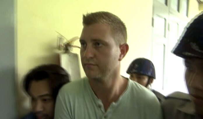Dutch citizen Klaas Haytema is escorted into a Myanmar court Thursday where he was sentenced to three months in prison for interfering with a religious observance, in Mandalay, Myanmar. Photo: Associated Press