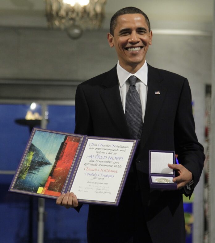 President and Nobel Peace Prize laureate Barack Obama poses with his medal and diploma at the Nobel Peace Prize ceremony in 2009 at City Hall in Oslo. Photo: John McConnico / Associated Press