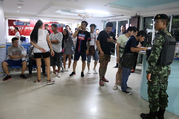 Sex show touts from Pattaya’s Walking Street on Monday night at the Pattaya City Police Station.