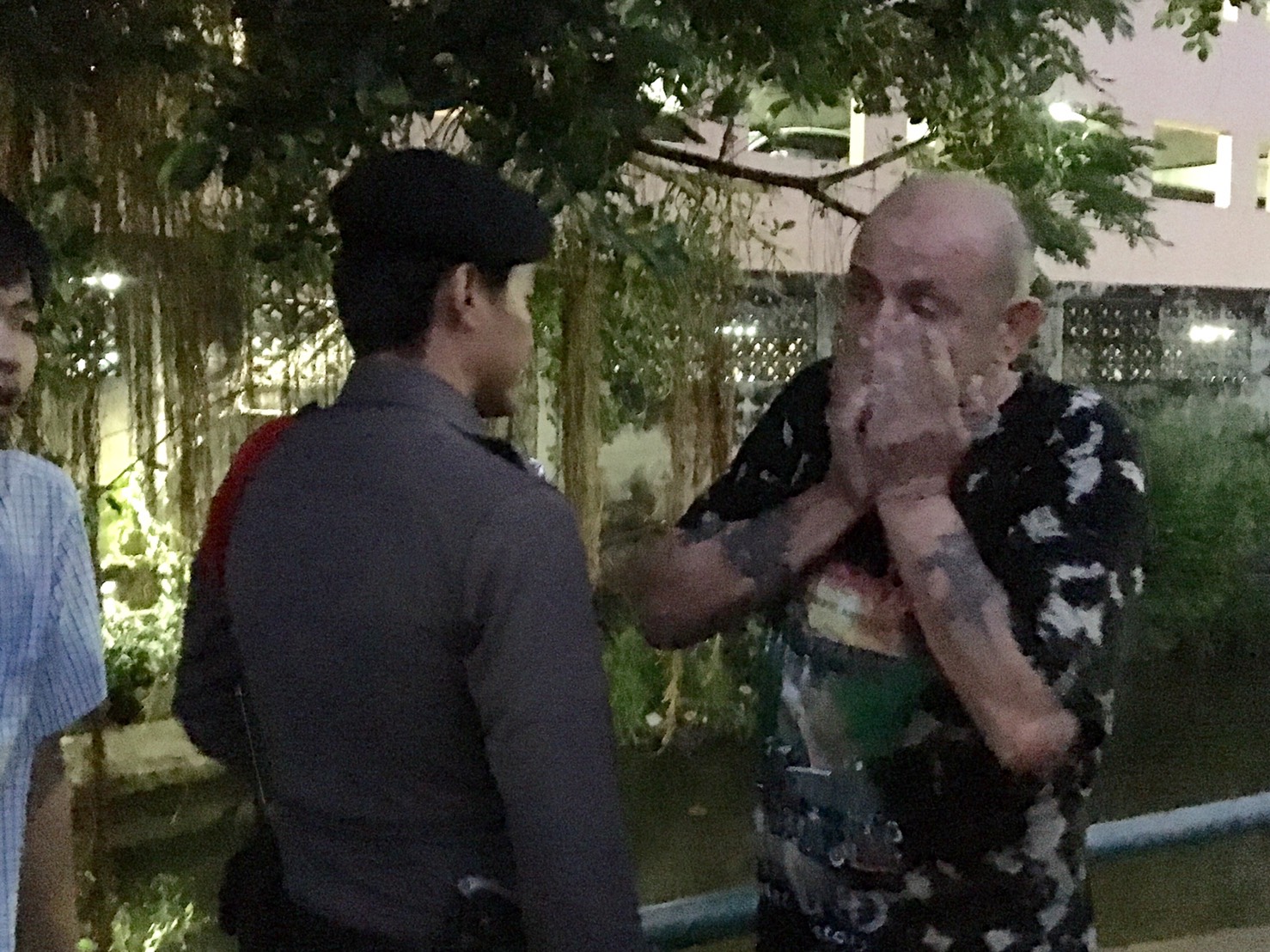 Daniells reacts at the scene of a 22-year-old Ugandan woman’s suicide this morning at a condo in Bangkok’s Rat Burana district.