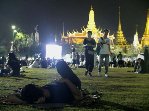 A man sleeps Wednesday night at Sanam Luang. 