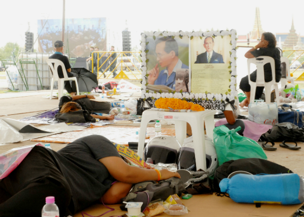 People sleep Thursday in the Sanam Luang.