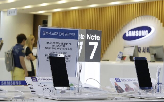 Customers wait for recall of their Samsung Electronics Galaxy Note 7 smartphones as powered-off Galaxy Note 7 smartphones are displayed at the company's service center Sunday in Seoul, South Korea. Photo: Ahn Young-joon / Associated Press