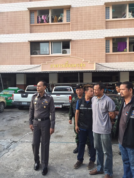 Preecha Samalee, second from right, is taken into custody Tuesday outside his condominium in Samut Prakan province.