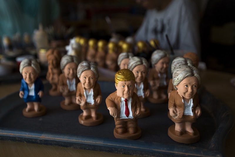 Clay miniatures of U.S. presidential candidates Hillary Clinton and Donald Trump are painted Monday in a "caganer" factory at Torroella de Montgri, northeast Catalonia, Spain. Photo: Emilio Morenatti / Associated Press