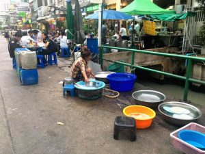 Alongside the Soi 19 street restaurant is also a visible dishwashing area.