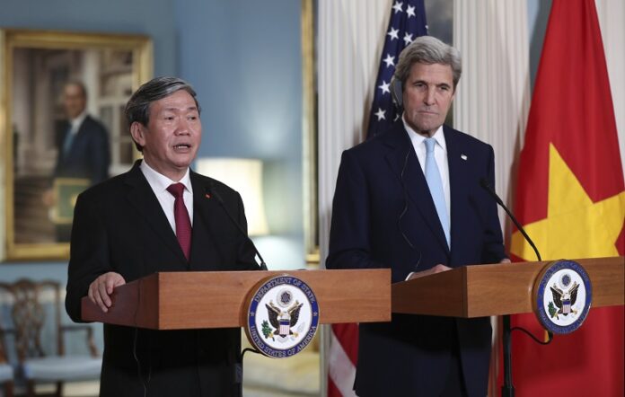 Vietnamese Executive Secretary Dinh The Huyn with Secretary of State John Kerry, speaks Tuesday to reporters in the Treaty Room at the State Department in Washington. Photo: Manuel Balce Ceneta / Associated Press