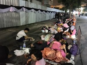 People slept overnight for a chance to view the royal procession bringing His Majesty King Bhumibol to the Grand Palace in Bangkok.
