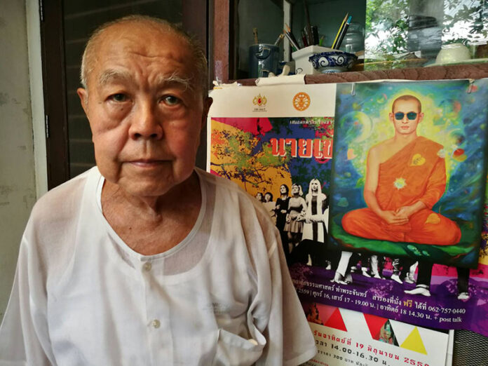 Historian Sulak Sivaraksa before a painting of King Bhumibol on Oct. 26, 2016, at his home in Bangkok's Bang Rak district.