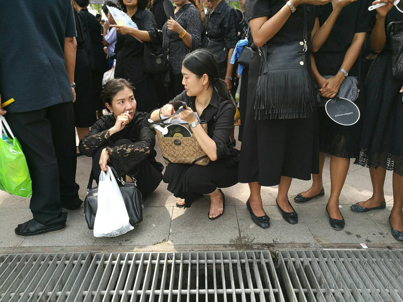 Suratchada Phuengphaophan, a 43-year-old office worker, and her friend Tunyaporn Teerateekanuwong, a banker, looked close to fainting Saturday at the Grand Palace in Bangkok.