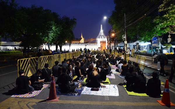 People queue outside the Grand Palace on Wednesday night to pay tribute to the late King when the gate opens at 8:30am. 