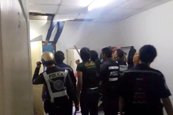 A moment before police prized Seksan Parinyaseri loose from the ceiling of an east Bangkok apartment early Friday morning.