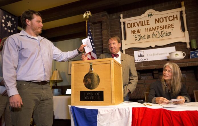 Dixville Notche's first voter Clay Smith drops his ballot into the box as moderator Tom Tillotson watches Tuesday, Nov. 8, 2016, in Dixville Notch, New Hampshire. Photo: Jim Cole / Associated Press