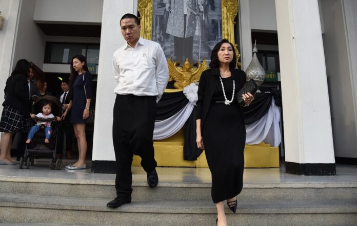Jenphop Viraporn and his mother leave the court on Monday in Ayutthaya province.