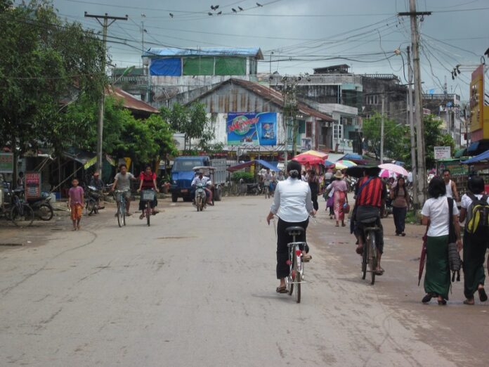 People walk in 2011 on the streets of Twante, Myanmar, where three girls were murdered Friday by an exorcist. Photo: Ken Marshall / Flickr