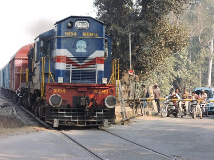 A train passes by a road intersection in 2013 in Lucknow, India, where at least 45 people were killed Sunday morning following a derailment. Photo: BOMBMAN / Flickr