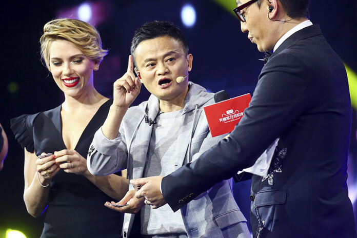 Hollywood actress Scarlett Johansson, at left, and Alibaba Group Chairman Jack Ma, at center, attend an evening gala on the eve of the Singles Day online shopping festival Thursday in Shenzhen in southern China's Guangdong province. Photo: Chinatopix / Associated Press